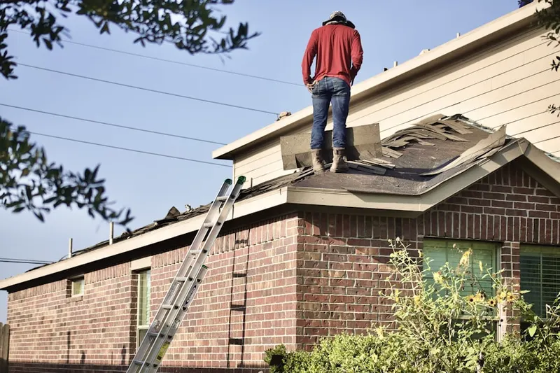 Professional roofer working on a residential roof in Yorkfield